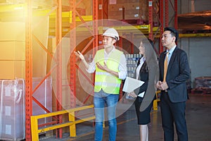 Businessman and engineer talking in the factory