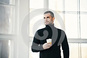 Businessman Enjoying Coffee Break by Window