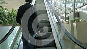 Businessman on Escalator