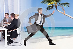 Businessman escaping from conference meeting towards beach