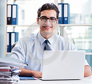 Businessman with excessive work paperwork working in office