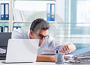 Businessman with excessive work paperwork working in office