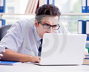 Businessman with excessive work paperwork working in office