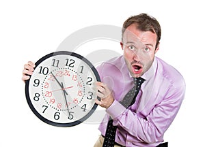 Businessman, executive, leader holding a clock, very determined, pressured by lack of time, running out of time, late for the meet
