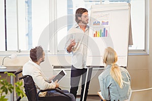 Businessman explaining multi colored graph