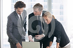 Businessman explaining presentation on laptop screen