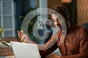 Businessman explaining something to a client over a headset