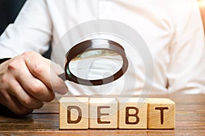 Businessman explores debt. Study of the structure of debt, restructuring and the abolition of penalties, illegal charges photo