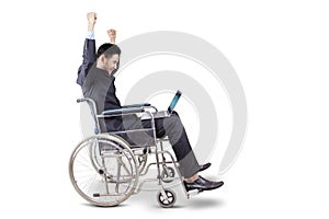 Businessman expressing his success on wheelchair