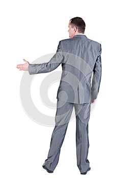 Businessman extending hand to shake. Rear view.