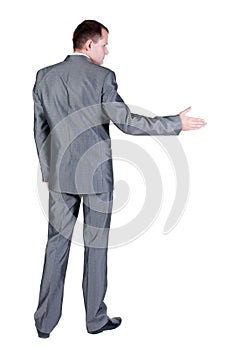 Businessman extending hand to shake. Rear view.