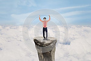 Businessman exulting above cloud outdoor