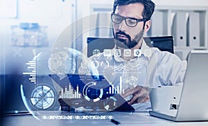 Businessman in eyeglasses with tablet, hud with earth globe and digital icons