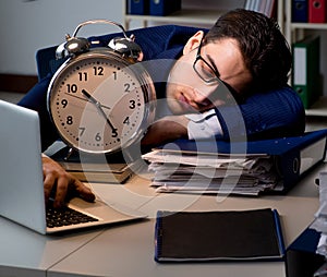 The businessman falling asleep during long hours in office