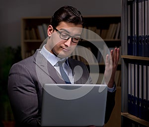 Businessman almost falling asleep working late hours in the offi