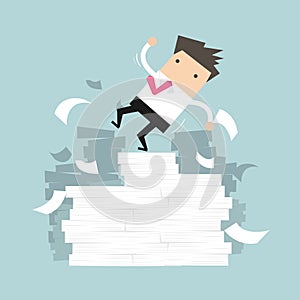 Businessman falling of paper mountain