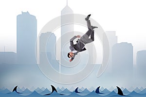 The businessman falling into sea with sharks