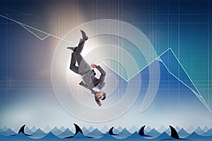 The businessman falling into sea with sharks