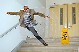 Businessman Falling on Stairwell