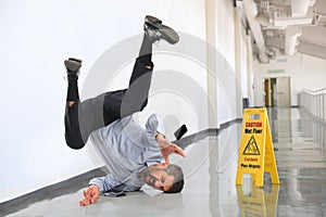 Businessman Falling on Wet Floor