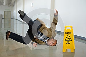 Businessman Falling on Wet Floor