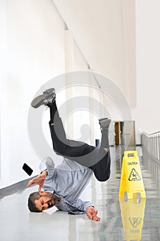 Businessman Falling on Wet Floor