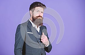 Businessman fashionable outfit stand violet background. Man bearded hipster wear classic suit outfit. Formal outfit