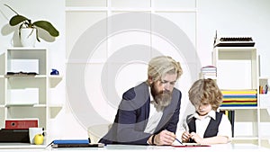 Businessman father with his son drawing on business papers at office. Team of business people having a meeting. Two