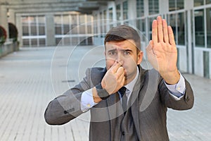 Businessman feeling grossed out at work photo