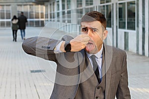 Businessman feeling grossed out at work