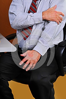 Businessman feeling pain in his left arm