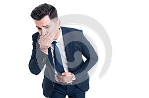 Businessman feeling sick from indigestion or food poisoning photo