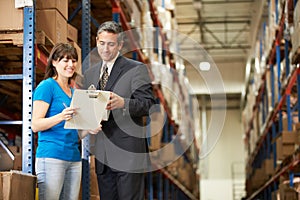 Businessman And Female Worker In Distribution Warehouse