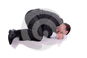 Businessman in fetal position