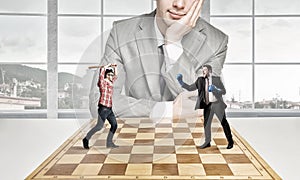 Businessman fighting on the chessboard