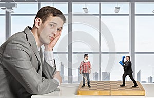 Businessman fighting on the chessboard