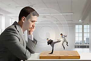 Businessman fighting on the chessboard