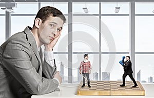 Businessman fighting on the chessboard