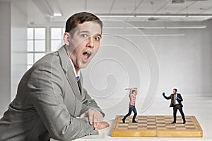 Businessman fighting on the chessboard