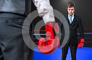 Businessman is fighting with his boss in boxing ring