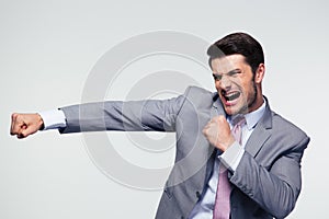Businessman fighting over gray background