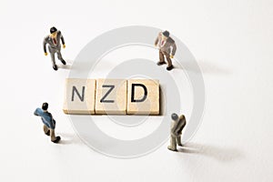 Businessman figures at NZD words
