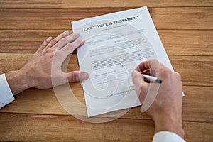 Businessman filling last will and testament form