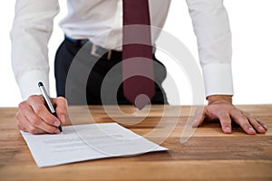 Businessman filling last will and testament form against white background