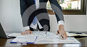 Businessman or financial market analysts work and calculate financial graphs that show investment results planning the process of