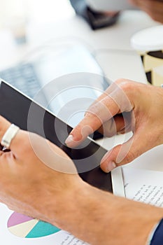 Businessman finger pointing to the screen of a digital tablet.