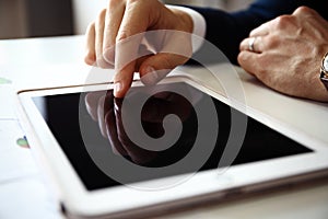 Businessman finger pointing to the screen of a tablet