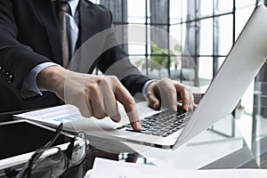 businessman finger typing on computer keyboard in office