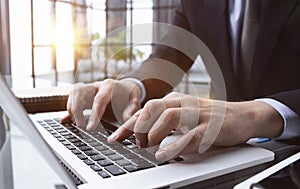 businessman finger typing on computer keyboard in office