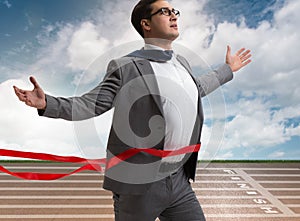 Businessman on the finishing line in competition concept